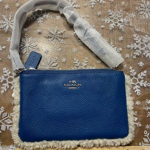 Blue leather and shearling wristlet